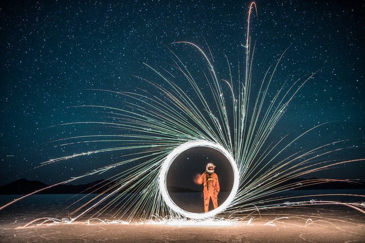 Circular spark play made by man in jump suit