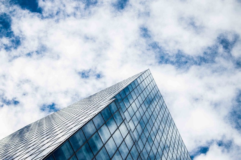 Building with cloudy skies