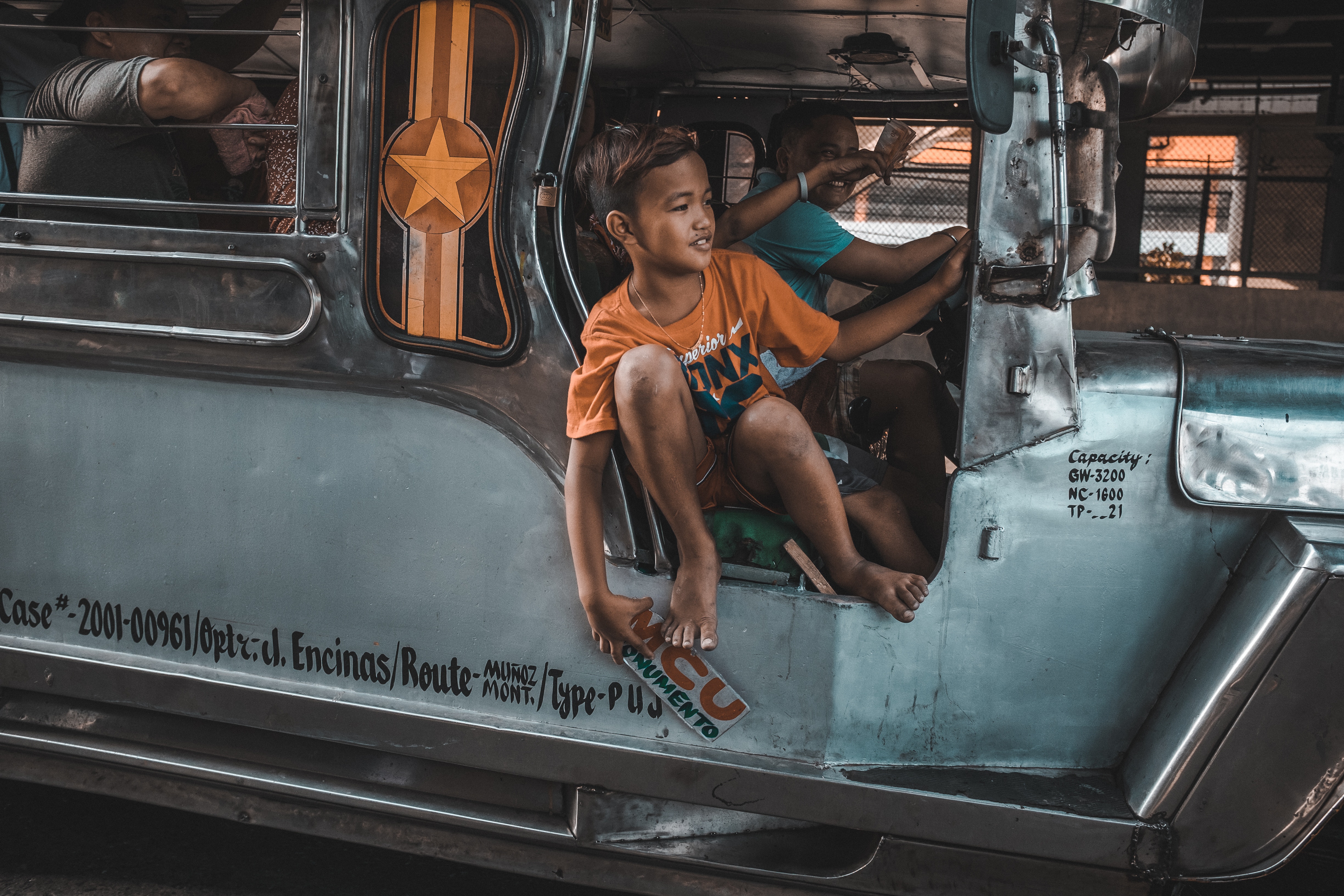 Kid calling riders to Jeepney