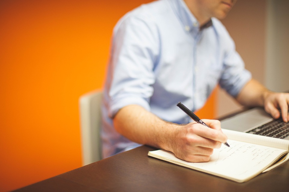 Young man taking down notes