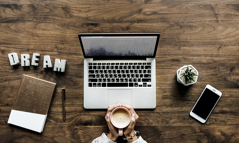 Working and drinking coffee in a wooden table