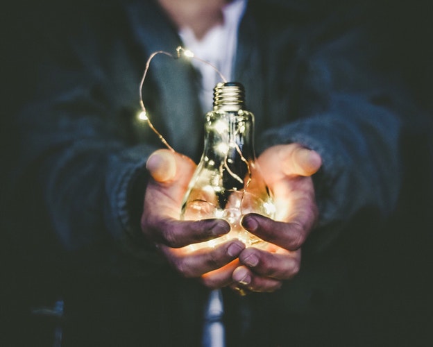 holding light bulb