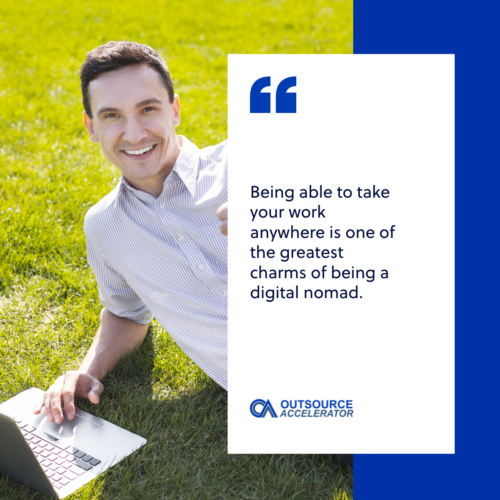 a man laying in the grass infront of laptop