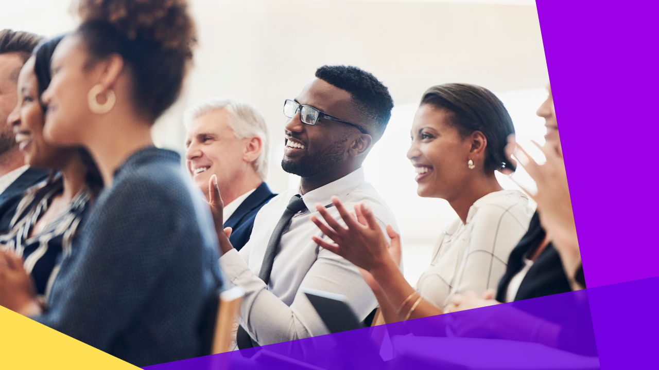 shot of a group of businesspeople clapping during a conference