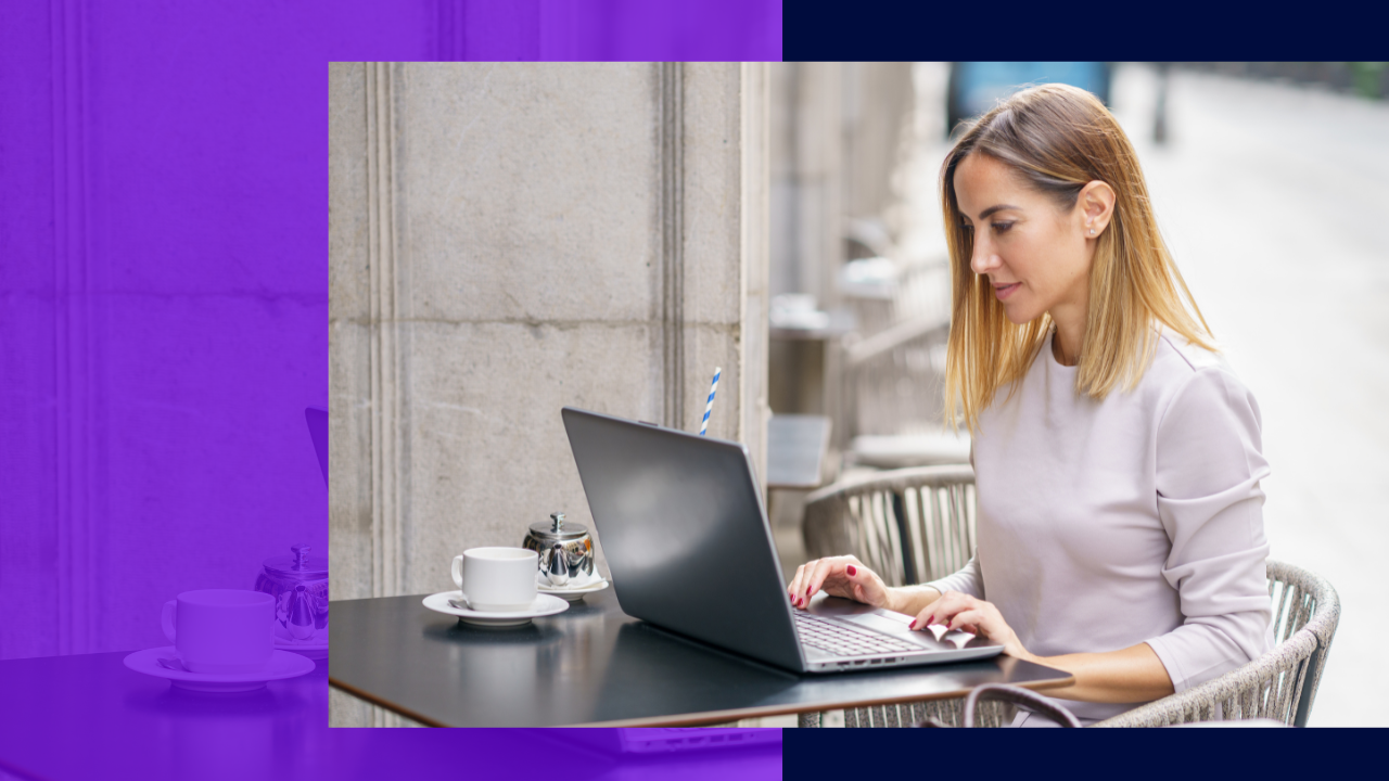 side view concentrated adult female freelancer with blond hair in casual clothes reading information on laptop while sitting in street cafe and working remotely