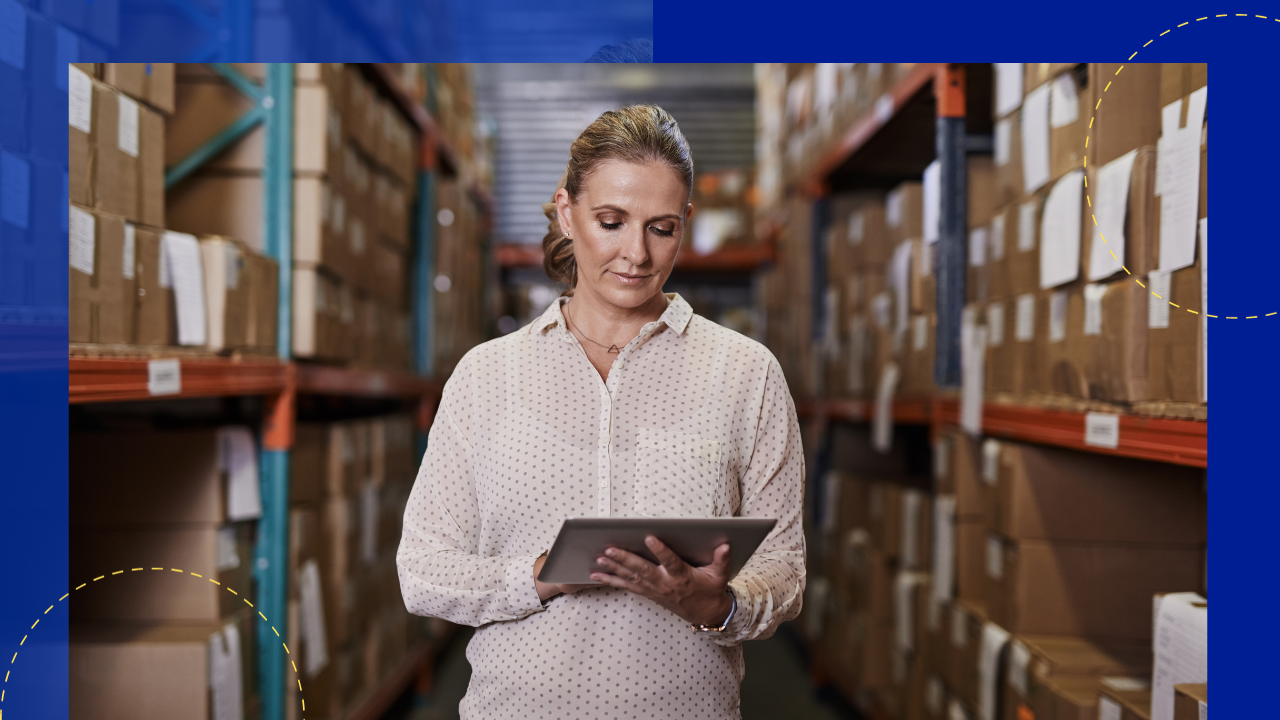 cropped shot of a mature female warehouse worker looking over the inventory