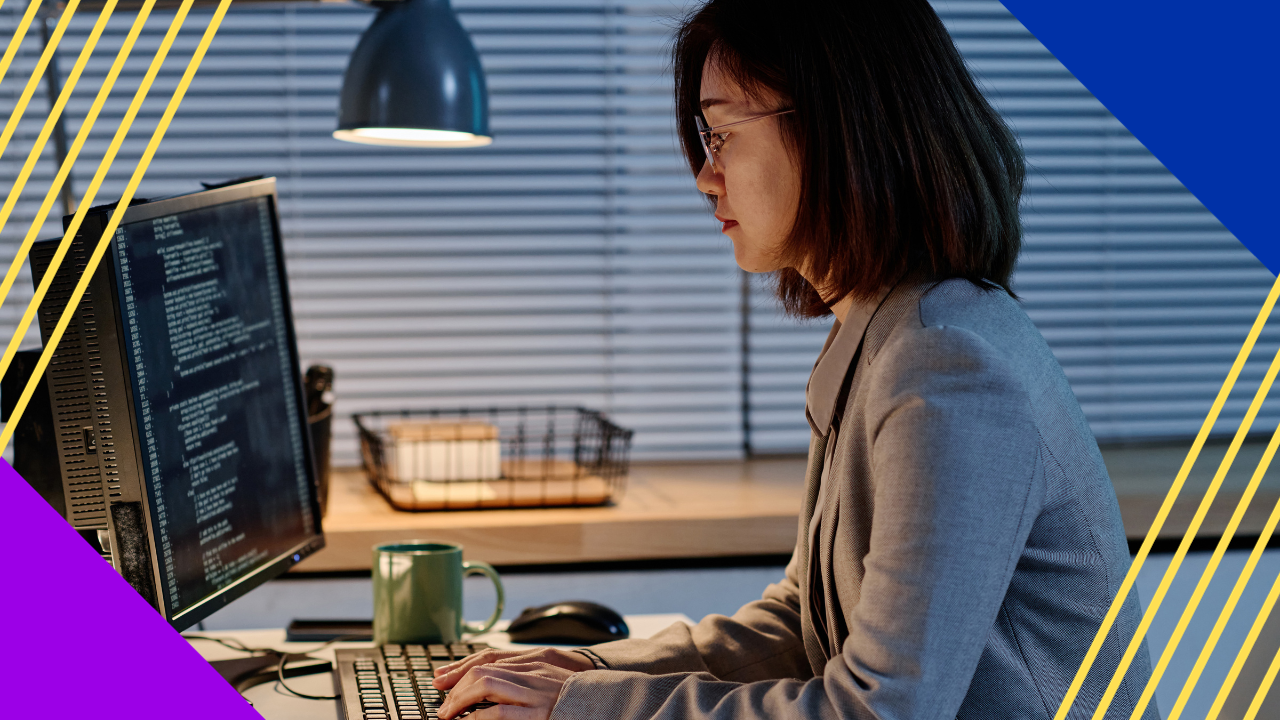 Asian it specialist typing codes for program om computer working at her workplace till late evening