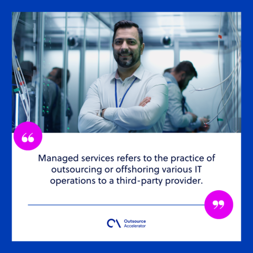 medium shots of a male manager smiling at the camera while working in a data center inbetween rows of server racks 