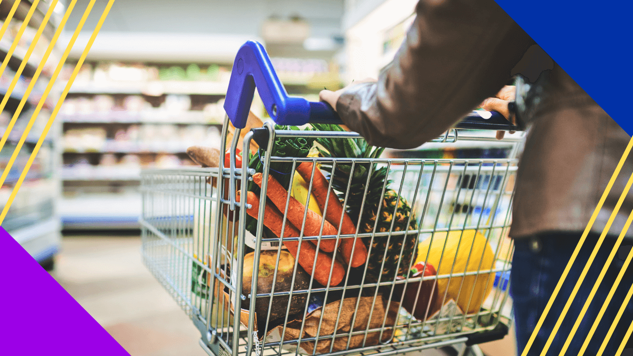 cropped shot of a woman pushing a trolley while shopping at grocery store