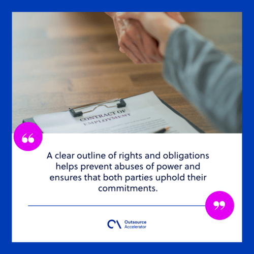 two people are standing at a table, across from each other and shaking hands after signing an employment contract