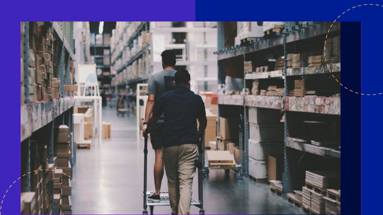 Two men push cart through warehouse aisles, illustrating Walmart's outsourcing-driven expansion.