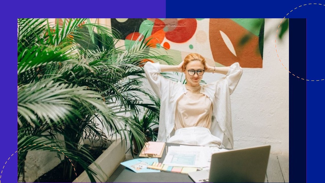 Relaxed professional behind desk with plants, boosting productivity without burnout through smart scaling.