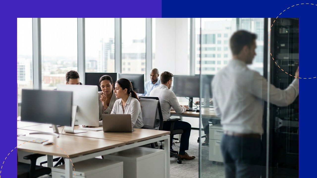 Team in modern office working with computers, reinforcing data protection with ISO 27002 compliance.