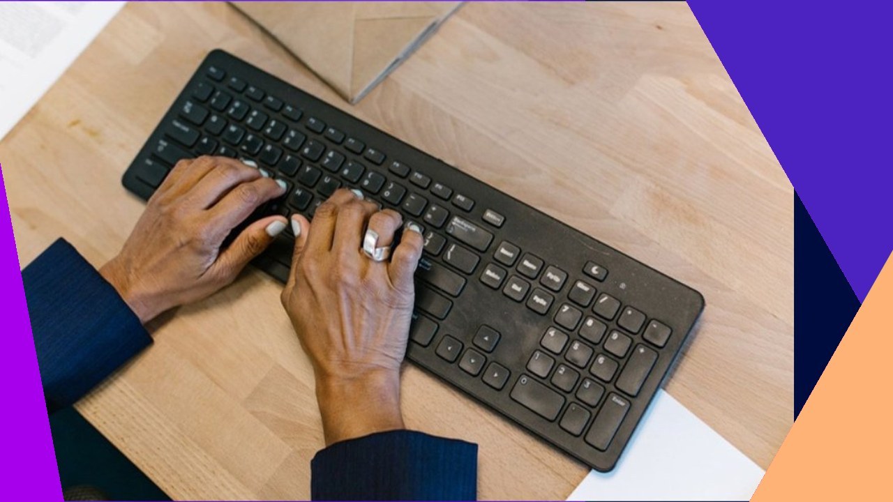 Hands typing on a keyboard, showcasing advantages of data entry and automation.