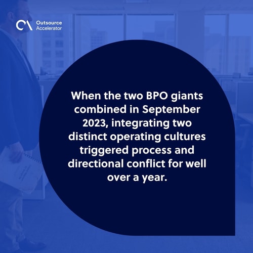 Post-merger BPO integration lead at the far left of a contact-centre delivery floor after a September 2023 giant-BPO combination