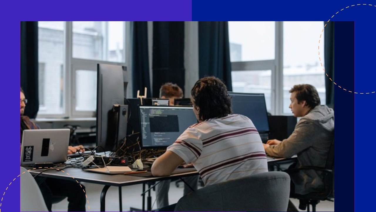 Developers in Vietnam working at desks with computers, setting up an offshore development center.
