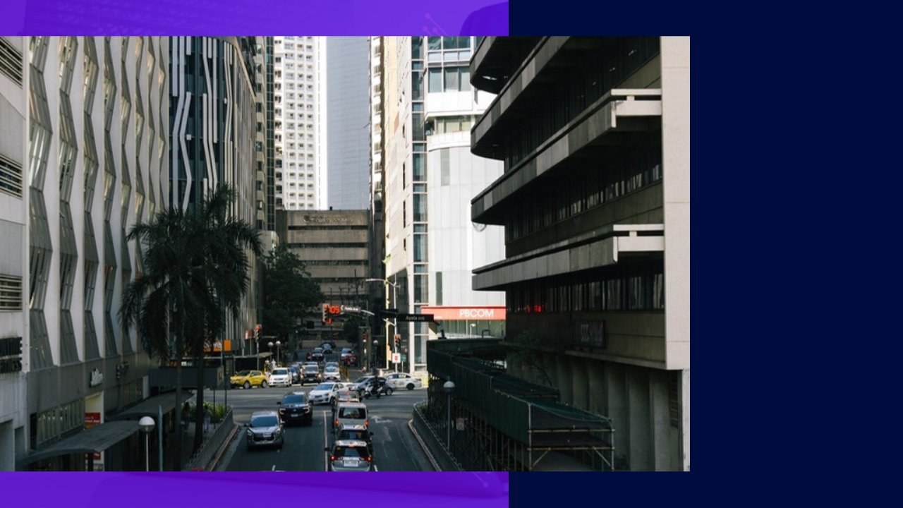 Modern skyscrapers and traffic on a Manila street, a key hub for outsourcing to the Philippines.