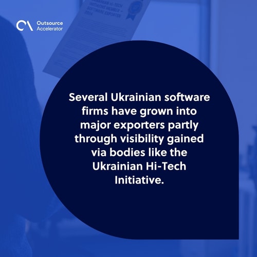 Ukrainian software-firm founder at the far-left edge of a Kyiv office holding a printed export tearsheet showing Ukrainian Hi-Tech Initiative software-exporter status