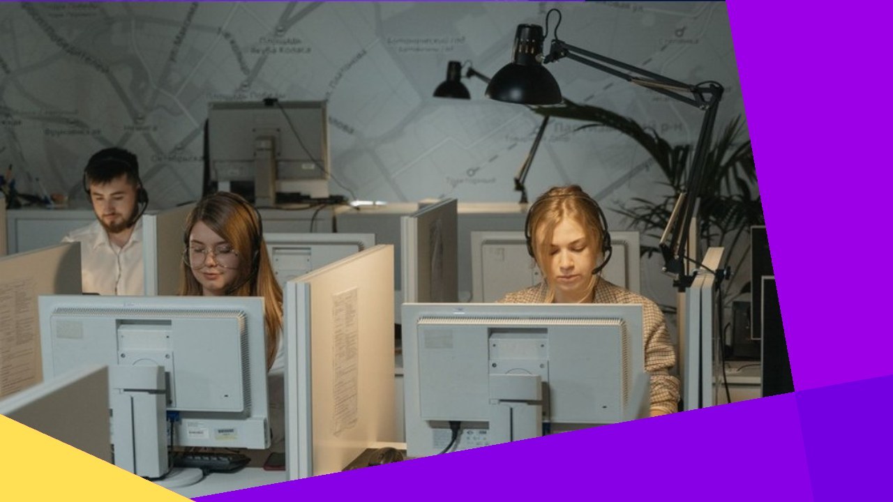 Call center agents working, illustrating top reasons to outsource call center services.