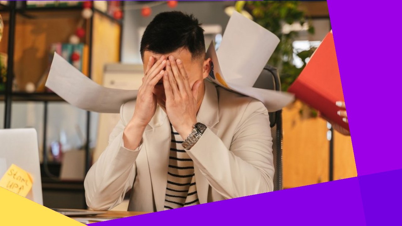 Stressed man with papers flying, needing a virtual assistant.