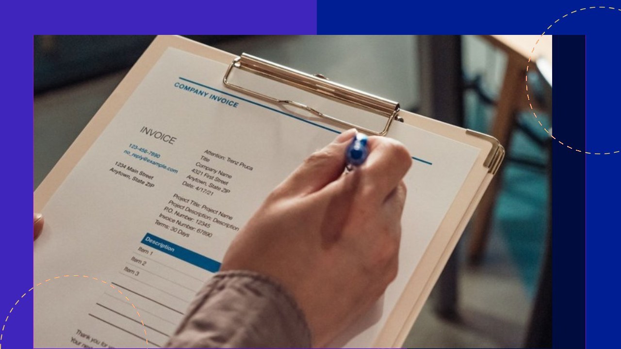 Hand filling out a company invoice, highlighting different invoice types and usage.