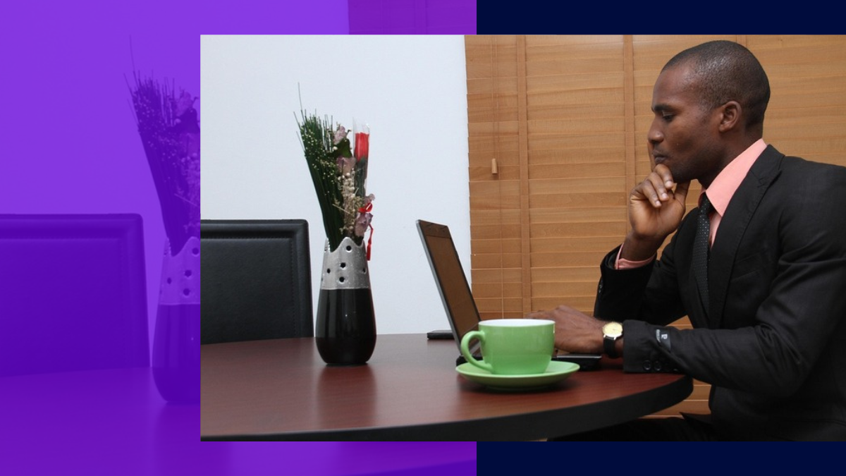 Professional at laptop in focused thinking pose — the response the World Bank describes as coming is already in the field