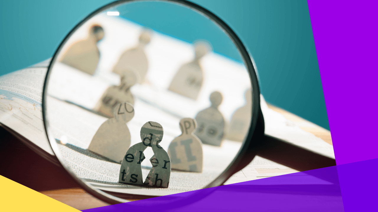 Magnifying glass over a paper cutout of person figures on a newspaper spread, one figure in focus, purple and yellow accent panels.
