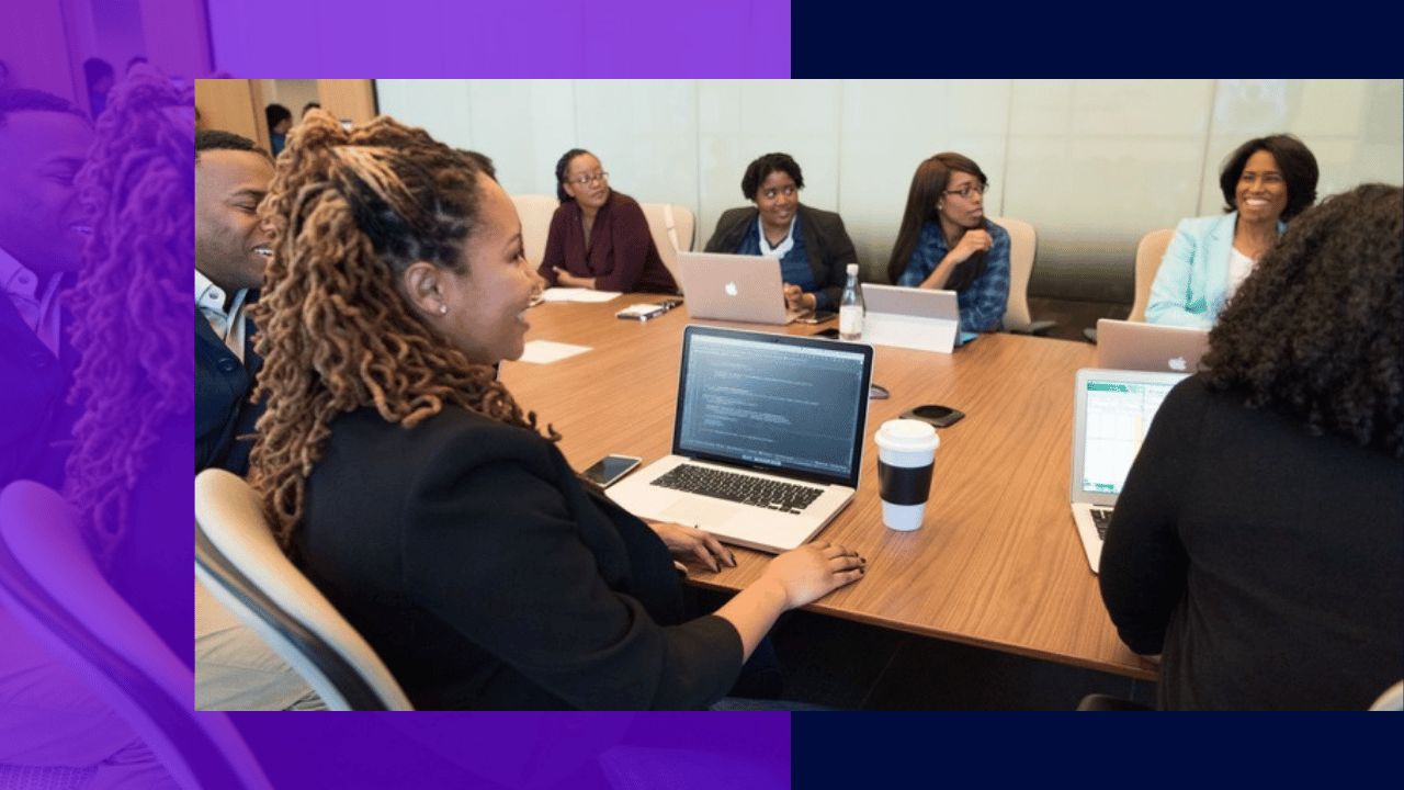 AI implementation in business - a team working on laptops around a conference table
