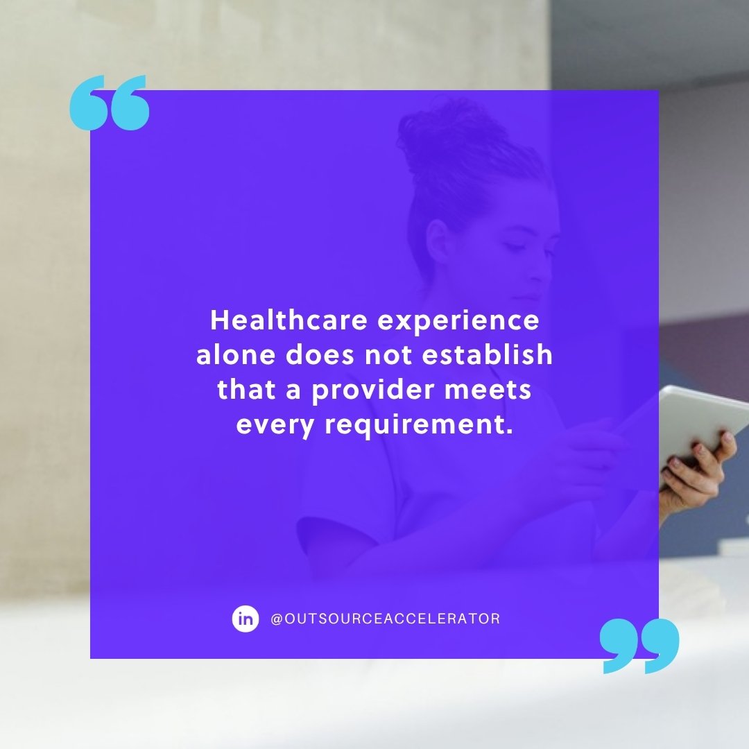 healthcare appointment scheduling - receptionist in scrubs reading a tablet at a front desk