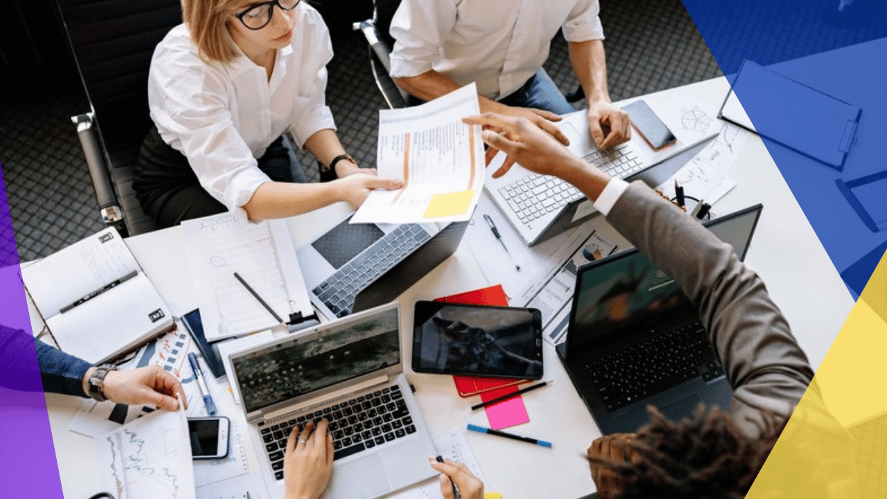 EOR compliance management - a team working on laptops around a shared table