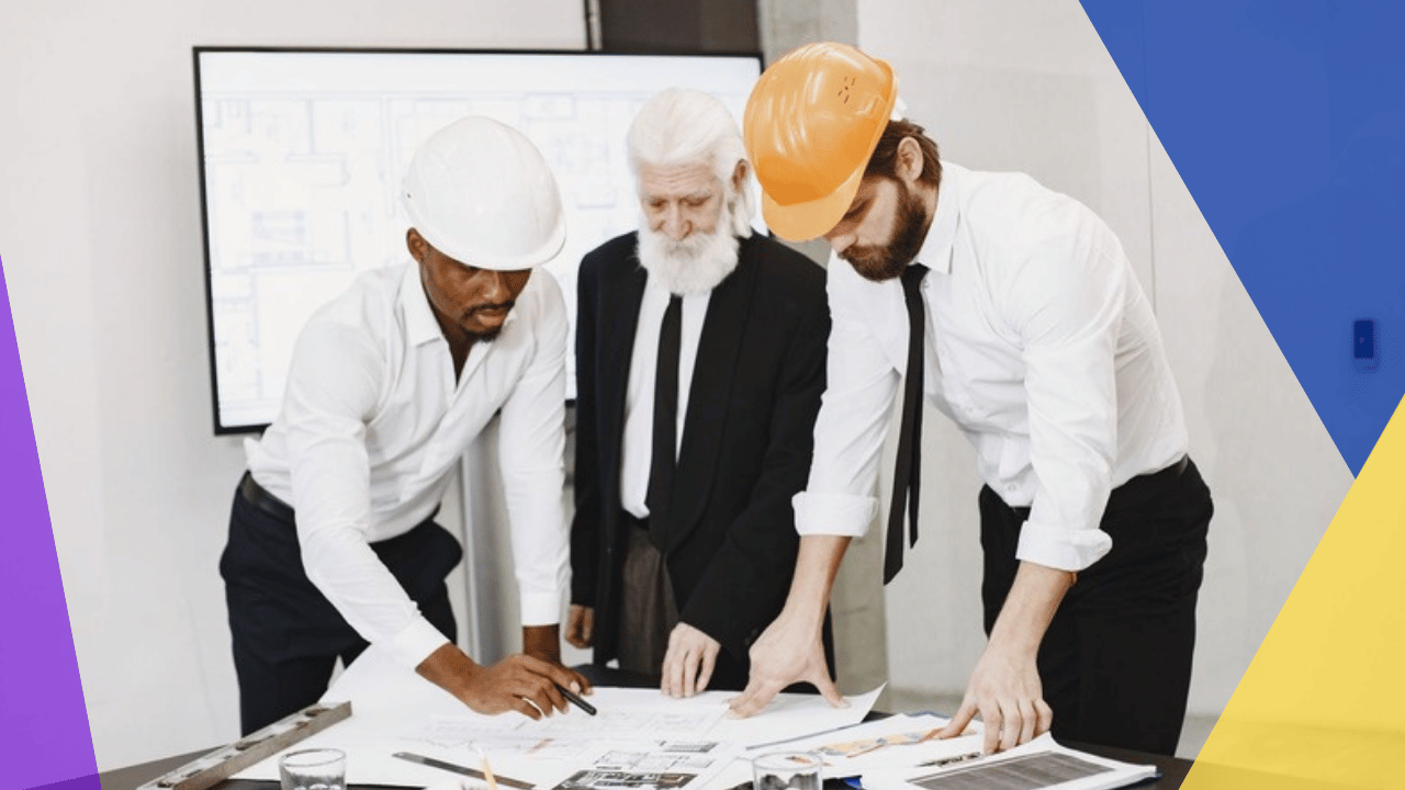 offshore construction estimator - three professionals in hard hats reviewing building plans in an office