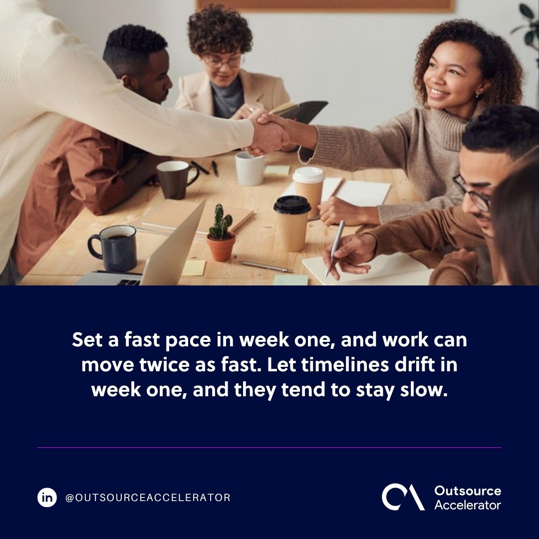 Offshore hire onboarding - a manager shaking hands with a new team member at a meeting table