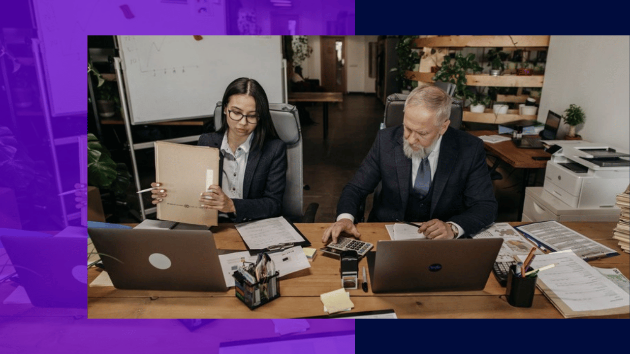 founder delegation - an executive and his assistant each working on a laptop at a shared desk